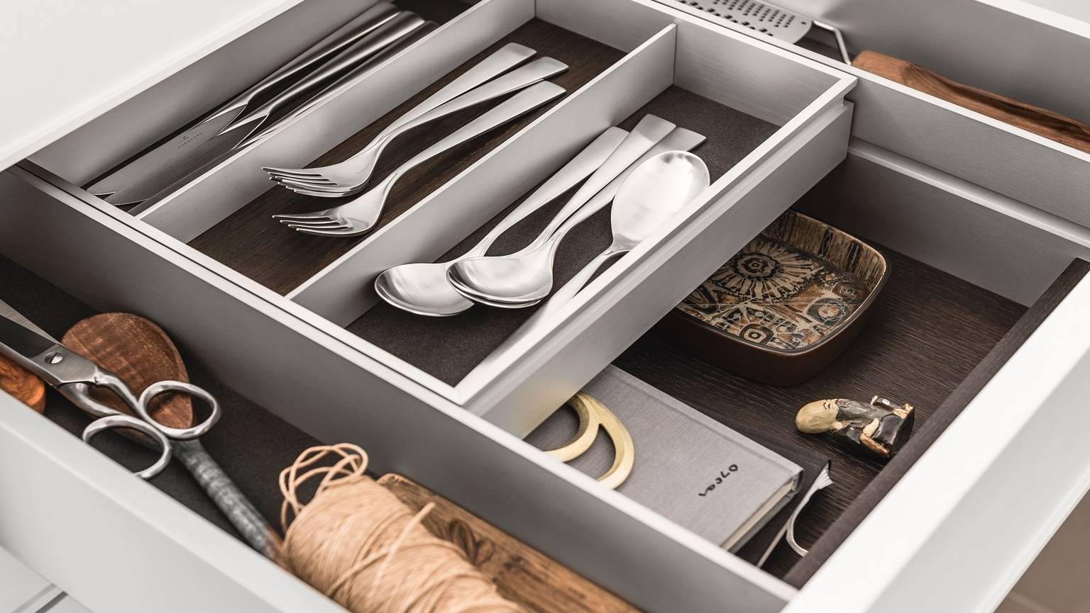 A bi-level drawer elegantly doubles storage space in SieMatic kitchen drawers and pull-outs