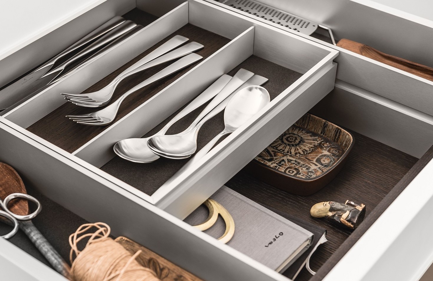 A bi-level drawer elegantly doubles storage space in SieMatic kitchen drawers