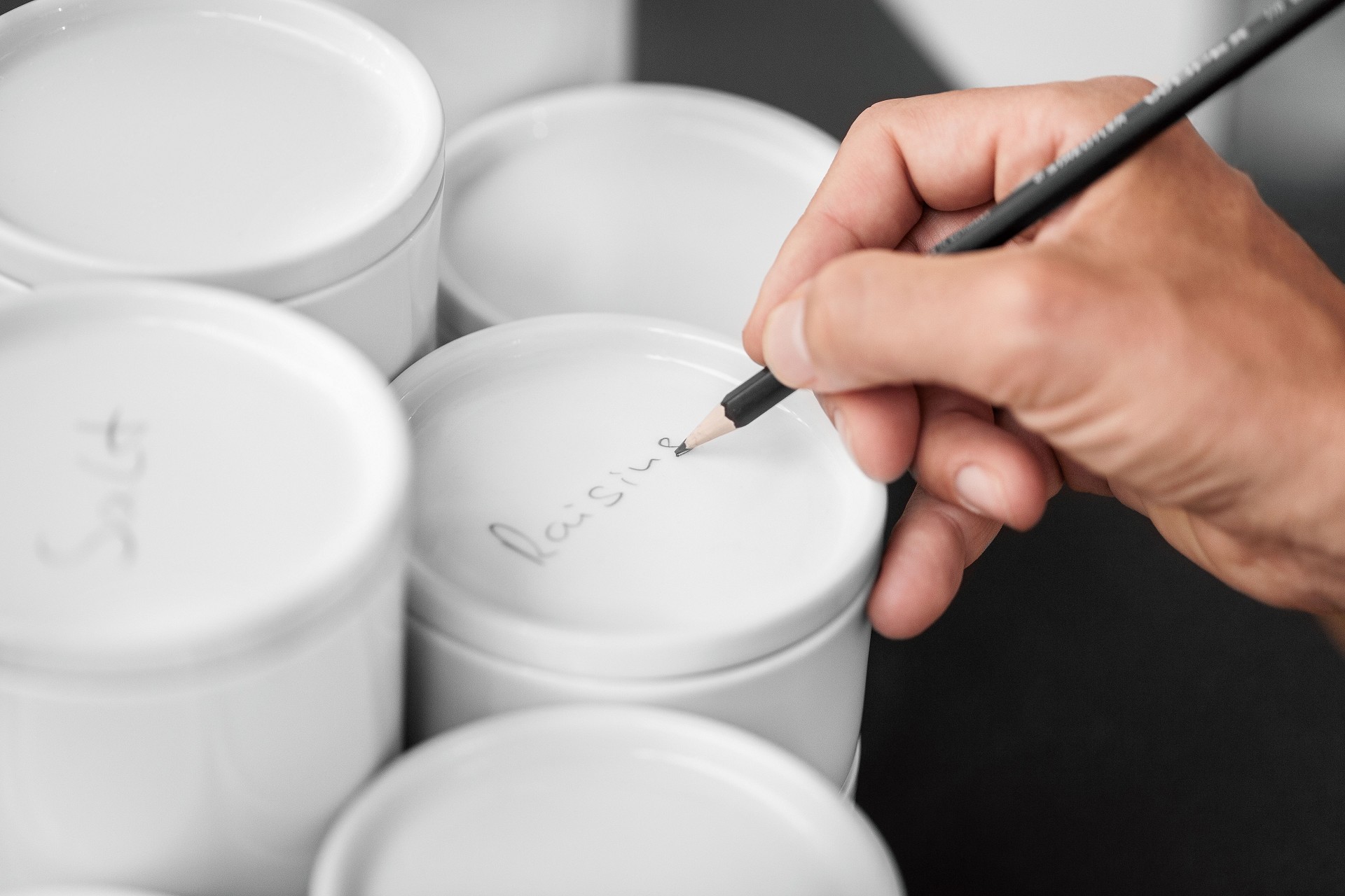 White SieMatic porcelain containers individually labeled in pencil