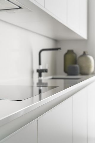 white kitchen cabinets with stainless steel worktop